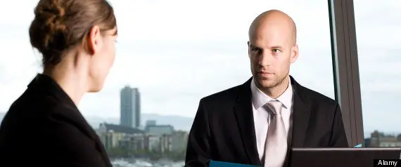 Young woman having a job interview, skeptical boss