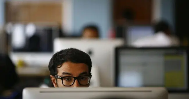 Employee works on his computer at the office of CloudFactory, a Canadian startup that based itself in Kathmandu
