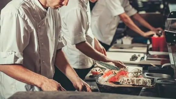 Busy chefs at work in the restaurant kitchen