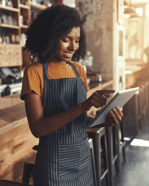VE woman using tablet in cafe portrait