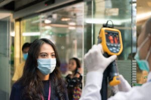 People waiting for temperature check by thermoscan