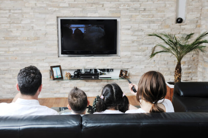 Happy young family have fun and working on laptop at modern  home livingroom indoor