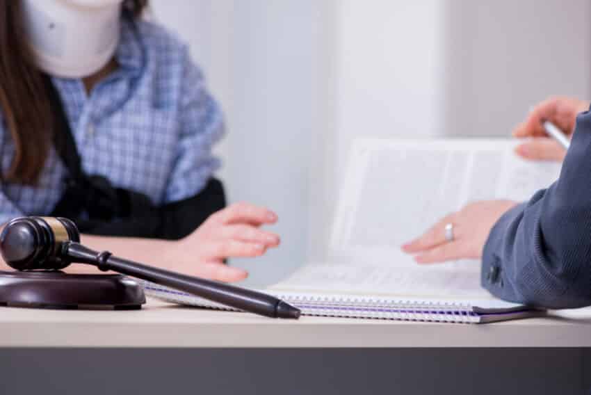 Injured employee visiting lawyer for advice on insurance