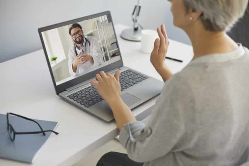 Cyber medicine. Mature lady talking to doctor online from home. Medical specialist consulting senior patient on webcam