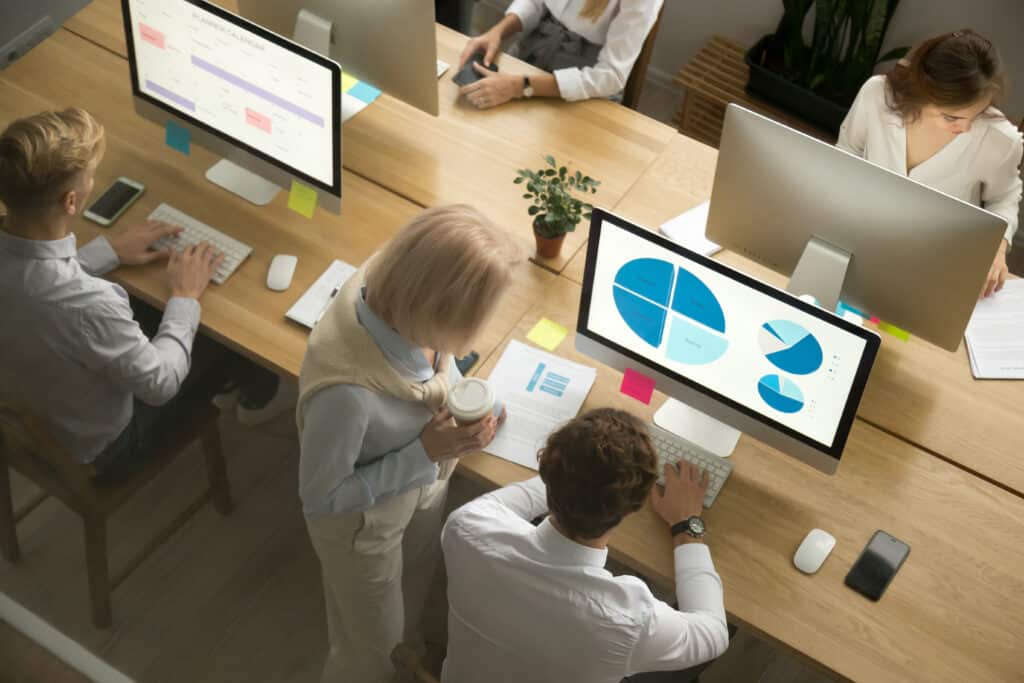 Corporate,Employees,Group,Working,On,Desktop,Pc,Computers,And,Talking