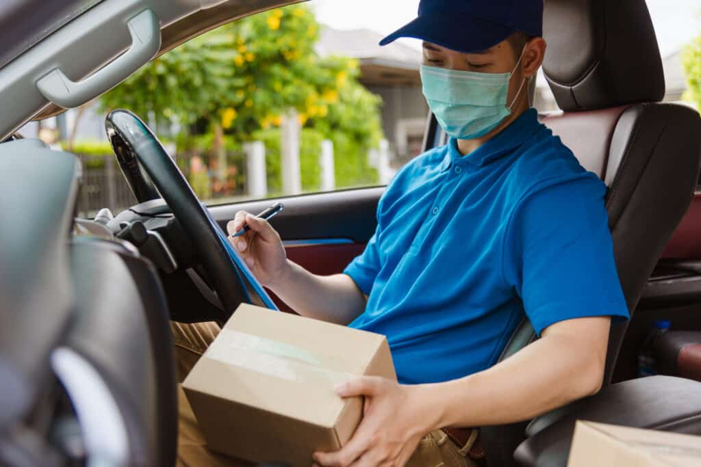 Asian,Delivery,Courier,Young,Man,Driver,Inside,The,Van,Car
