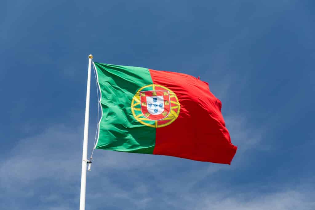 Beautiful,Large,Portuguese,Flag,Waving,In,The,Wind,Against,Blue