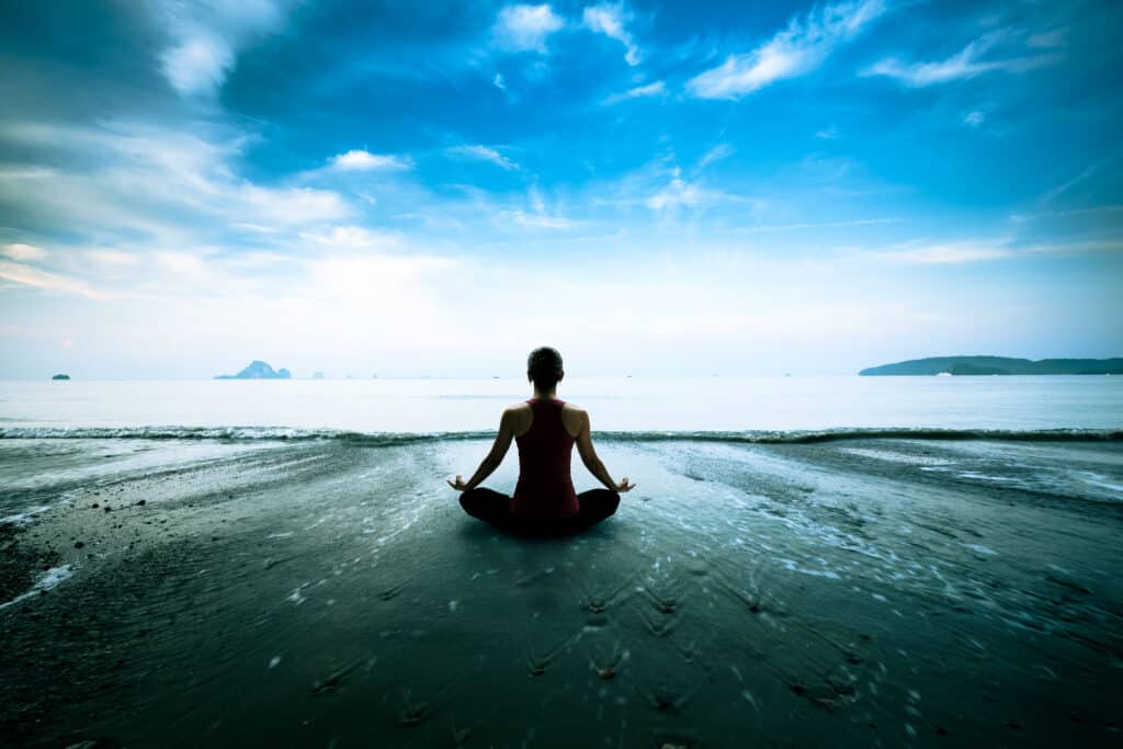 Silhouette,Young,Woman,Practicing,Yoga,On,The,Beach