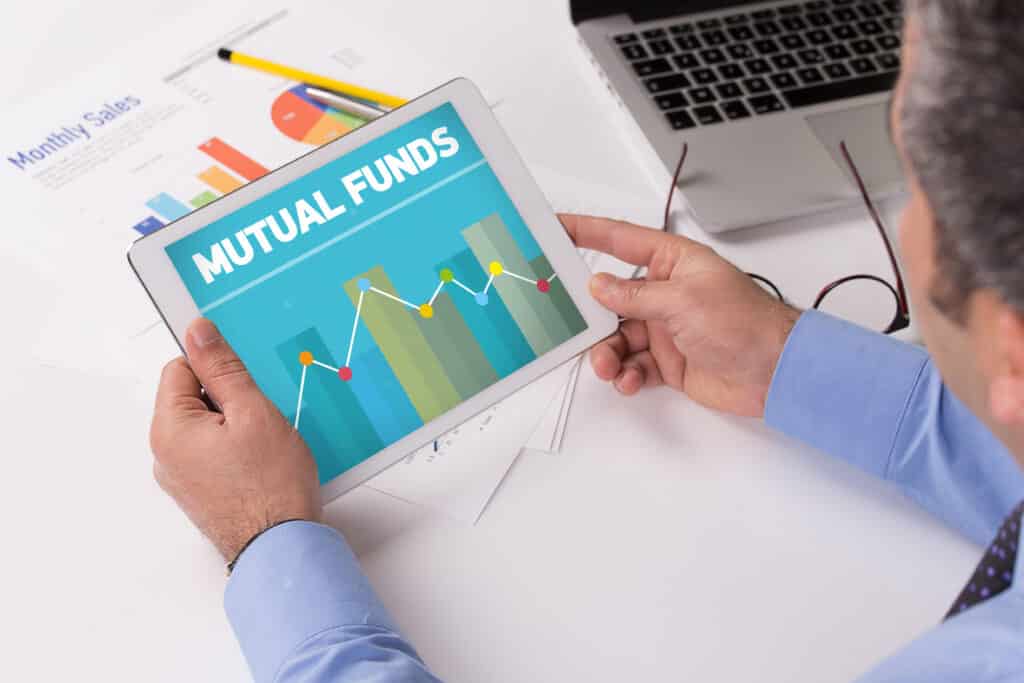 Man,Working,On,Tablet,With,Mutual,Funds,On,A,Screen