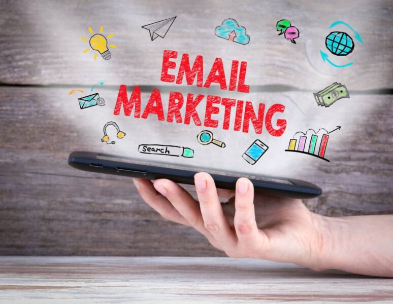 Email,Marketing,Concept.,Tablet,Computer,In,The,Hand.,Old,Wooden