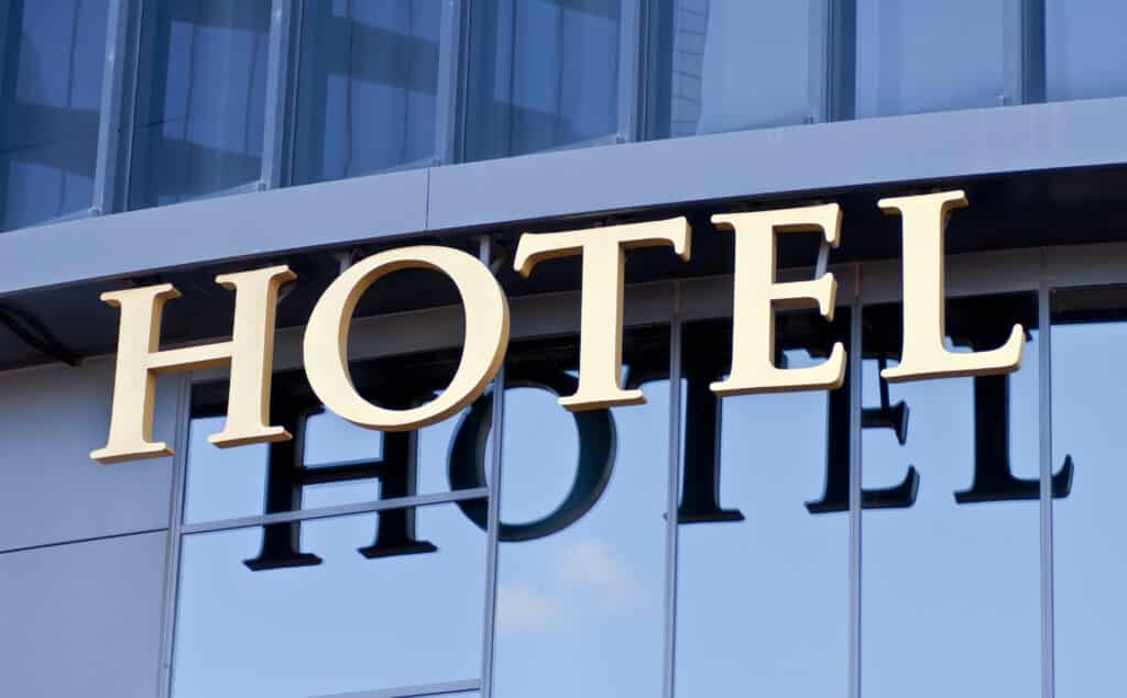 A,Hotel,Sign,Reflected,In,The,Glass,Of,The,Building