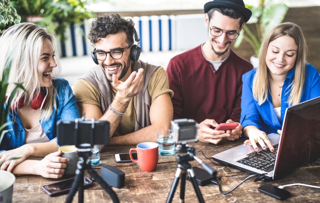 Young,Happy,Friends,Sharing,Content,On,Streaming,Platform,With,Digital