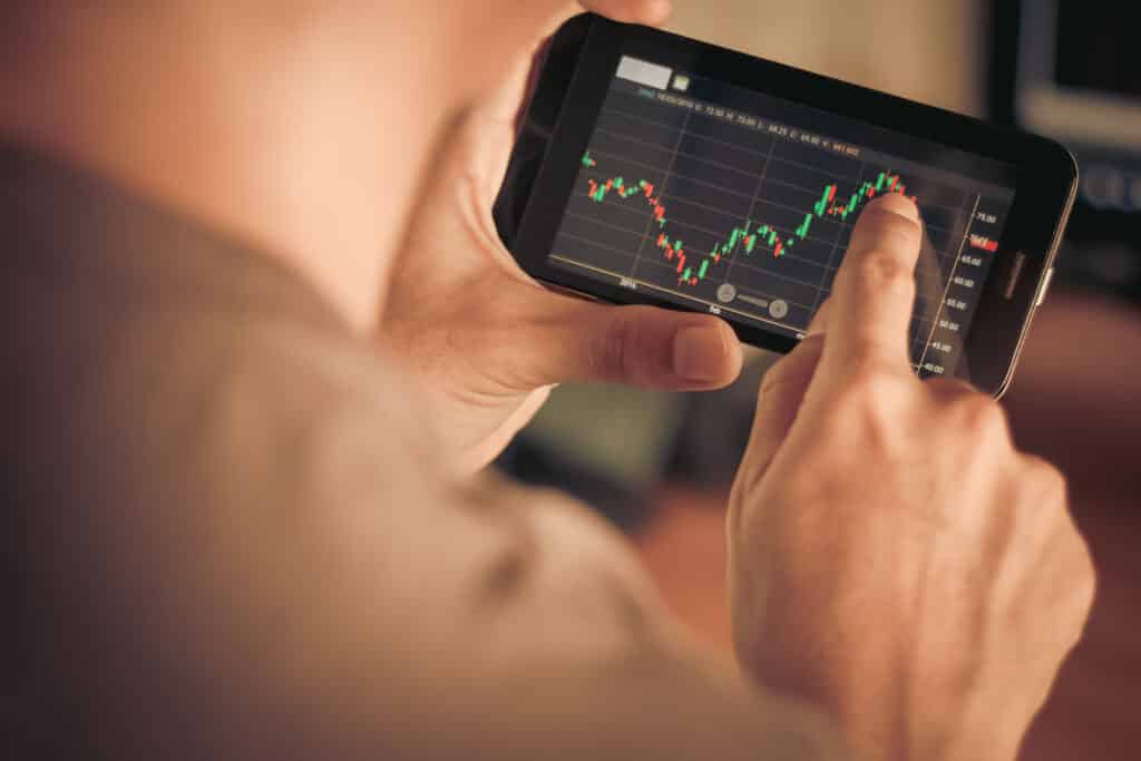 A,Man,Checking,Stock,Market,On,Smartphone