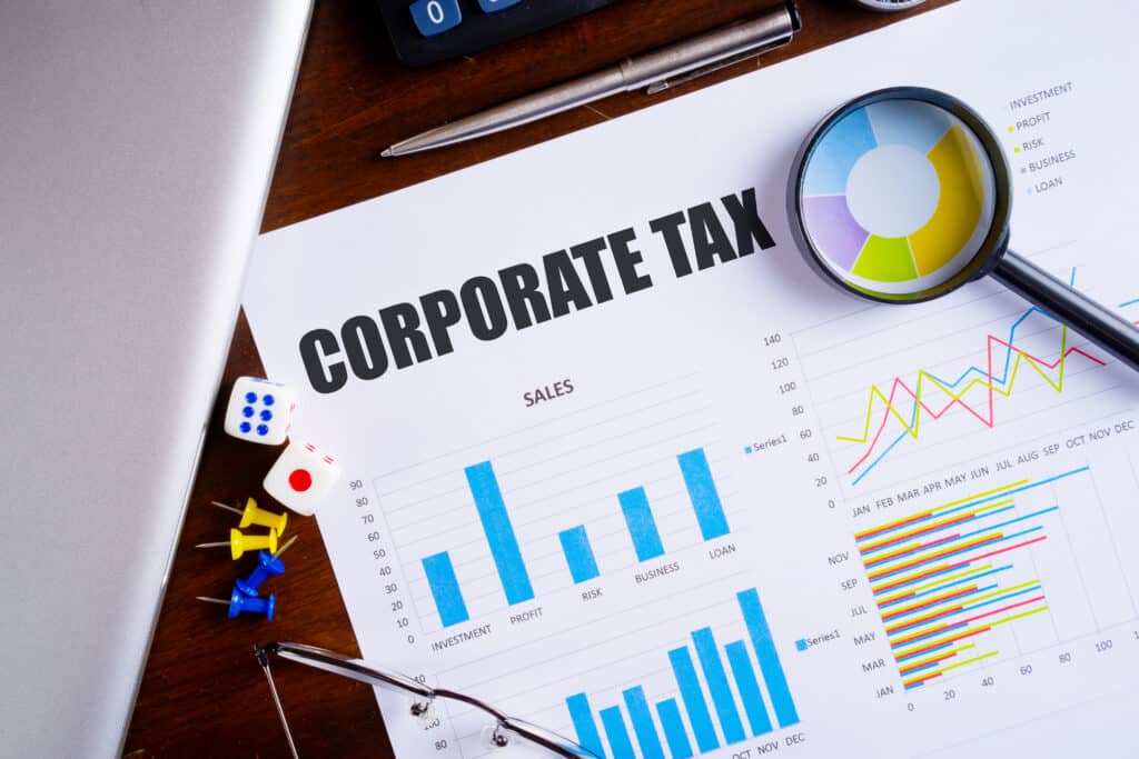 “corporate,Tax”,Text,On,Paper,Sheet,With,Magnifying,Glass,On