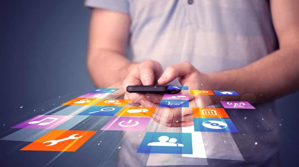 Man,Holding,Smart,Phone,With,Colorful,Application,Icons,Comming,Out
