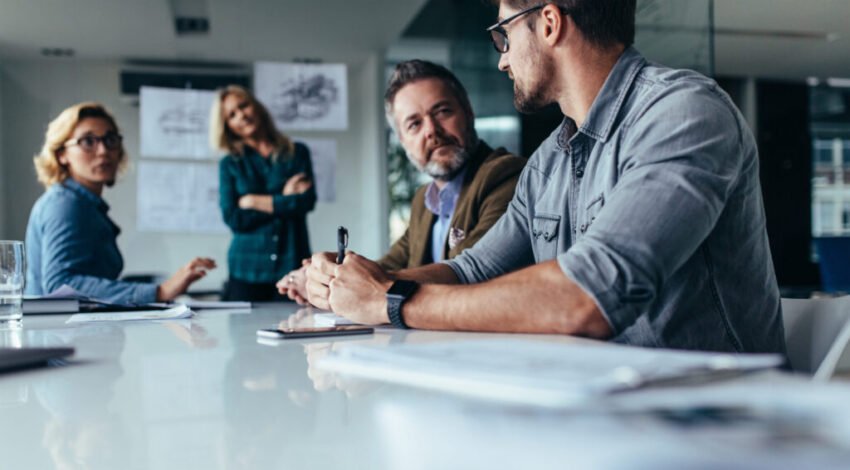Businessman,Explaining,New,Business,Ideas,To,Peers.,Business,People,Discussing