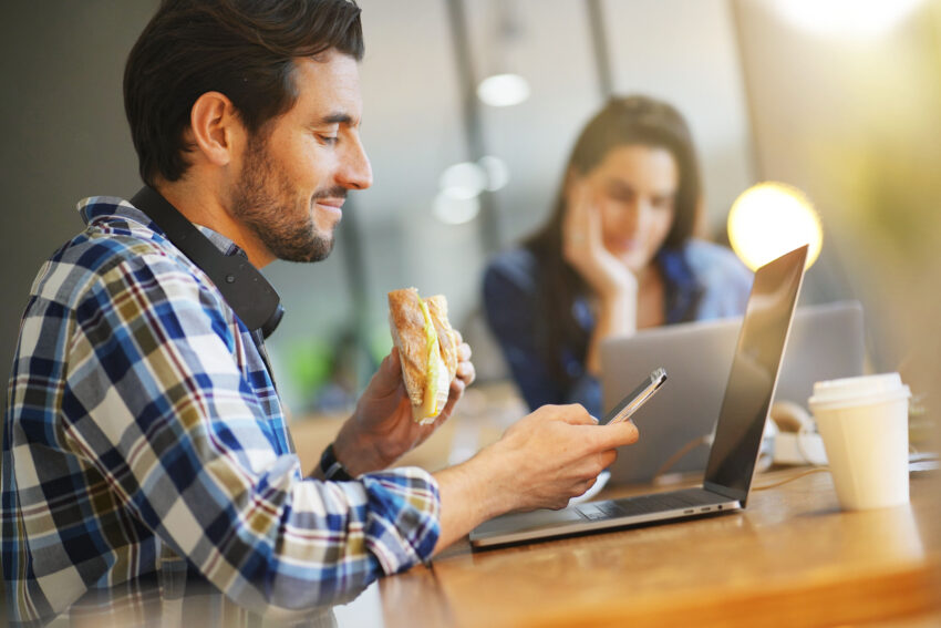 Attractive,Man,Eating,Sandwich,Whilst,Working,In,Co,Working,Space