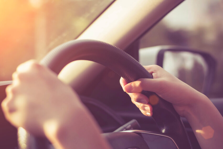 Female,Hands,On,The,Steering,Wheel,Of,A,Car,While