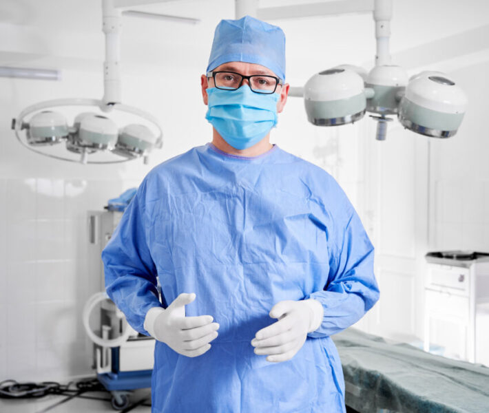 Portrait,Of,Doctor,In,Glasses,Looking,At,Camera,While,Standing