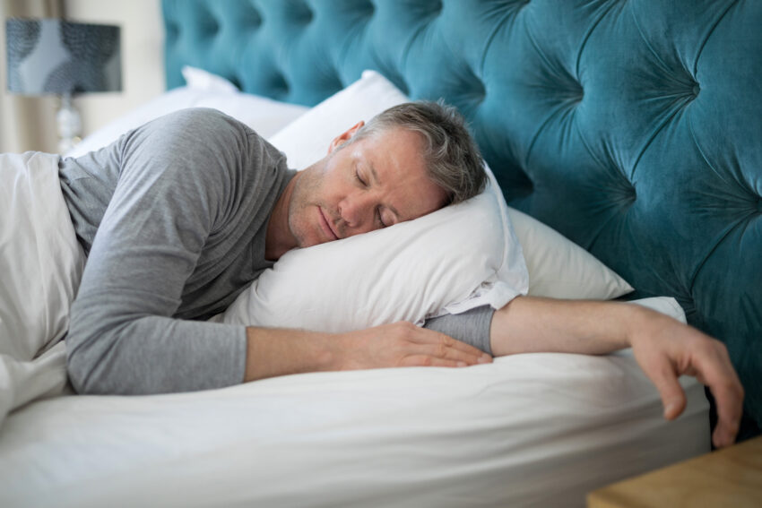 Man,Sleeping,On,Bed,In,Bedroom,At,Home
