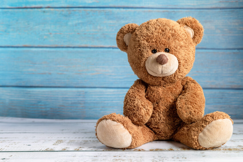 Cute,Teddy,Bear,With,Copy,Space,On,Blue,Color,Wood