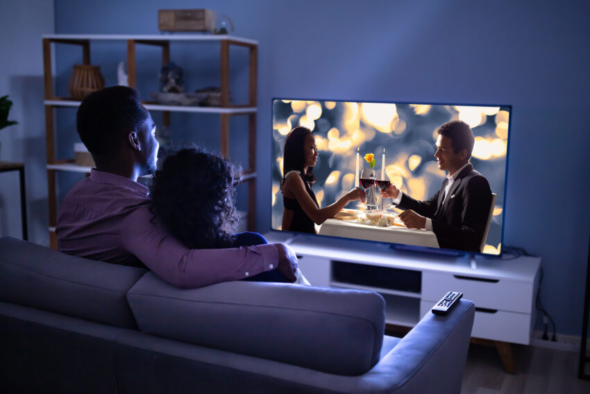 Affectionate,Young,Family,Watching,Tv,At,Home