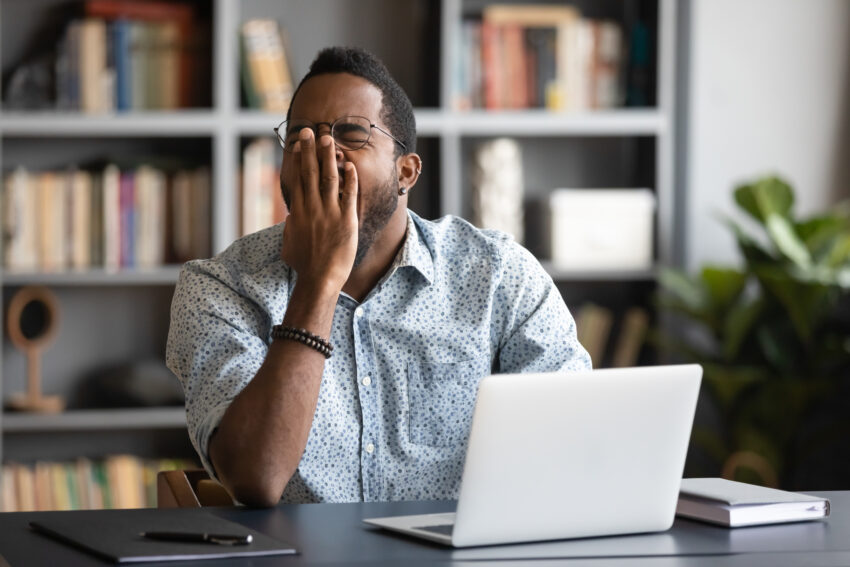 Tired,African,American,Male,Worker,Or,Student,Sit,At,Desk
