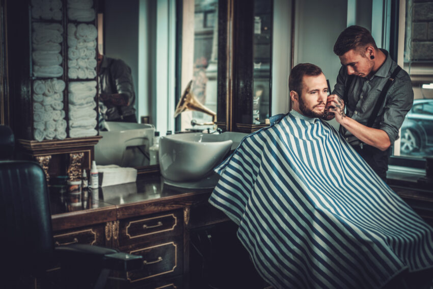 Confident,Man,Visiting,Hairstylist,In,Barber,Shop
