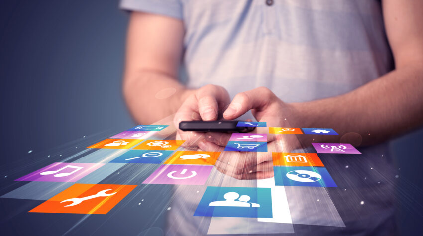 Man,Holding,Smart,Phone,With,Colorful,Application,Icons,Comming,Out
