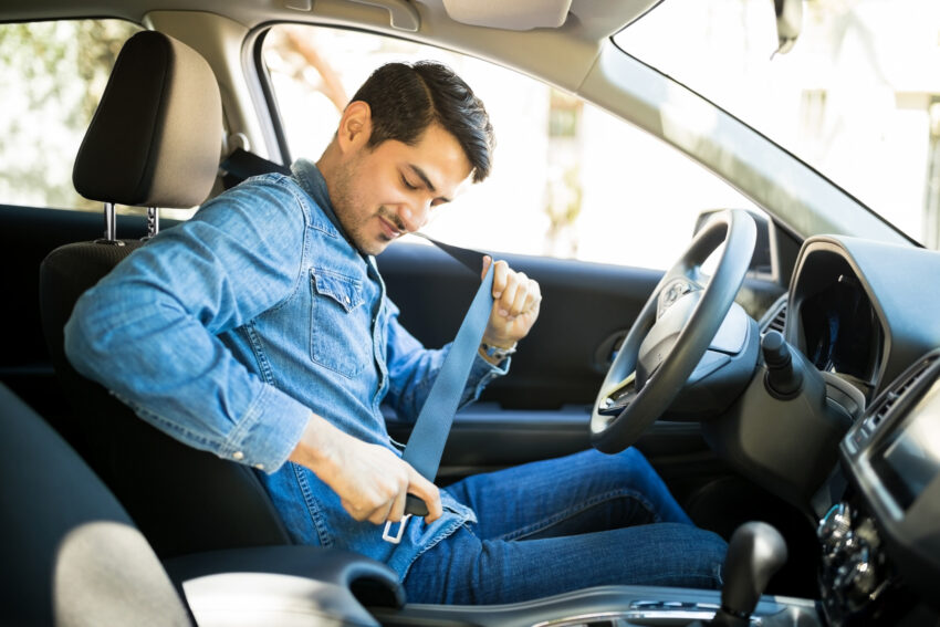 Young,Latin,Man,Sitting,On,Car,Seat,Fastening,Seat,Belt