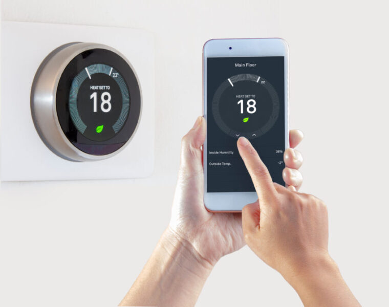 Smart,Thermostat,With,A,Person,Saving,Energy,With,A,Smart