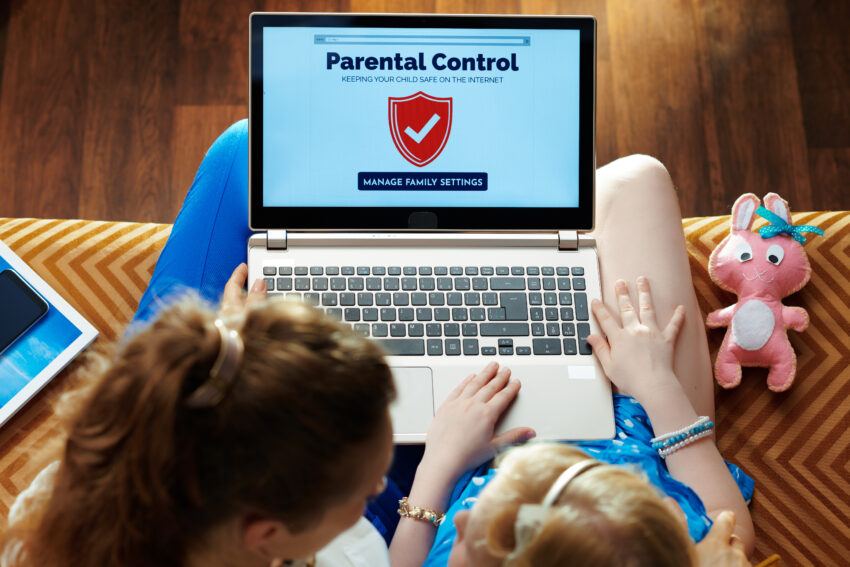 Modern,Mother,And,Daughter,Sitting,On,Sofa,In,The,Modern