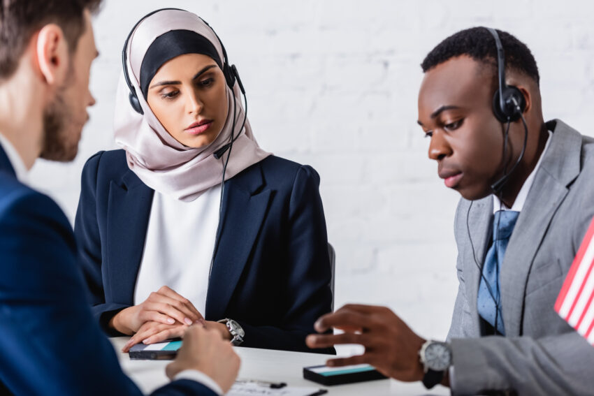 Arabian,And,African,American,Business,People,In,Headsets,Near,Digital