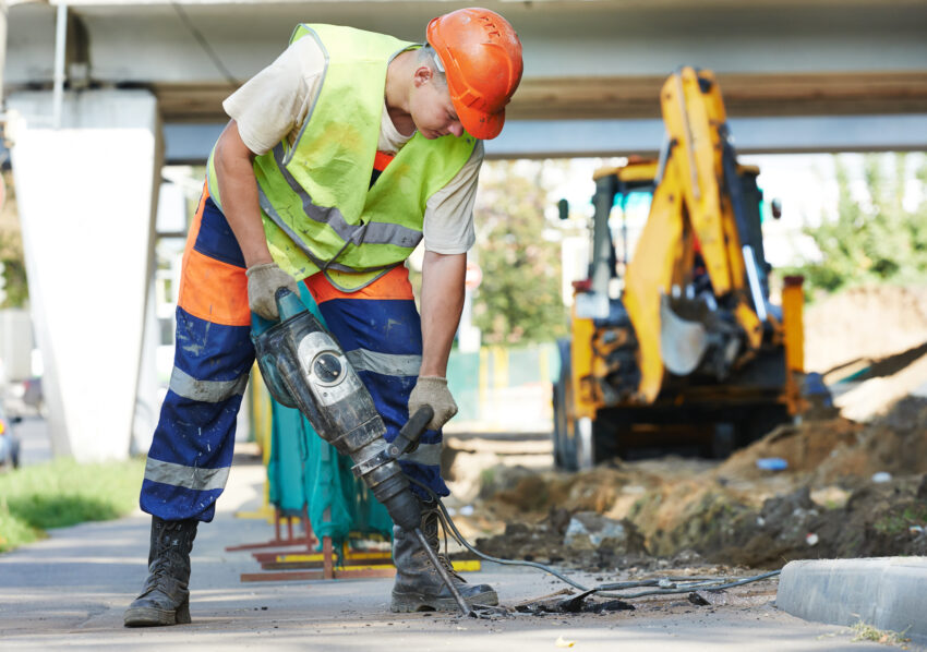 Builder,Worker,With,Pneumatic,Hammer,Drill,Equipment,Breaking,Asphalt,At