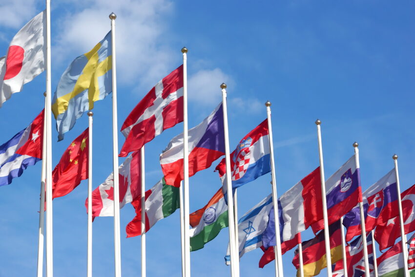 World,Flags,Blowing,In,The,Wind,On,The,Cloudy,Sky