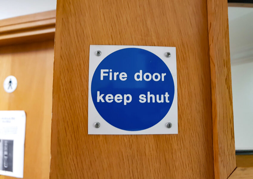 A,Small,Square,Blue,Fire,Door,Sign,On,A,Light