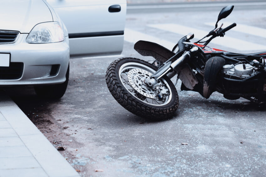 Motorcycle,Lying,On,The,Road,And,Car,Standing,With,Open