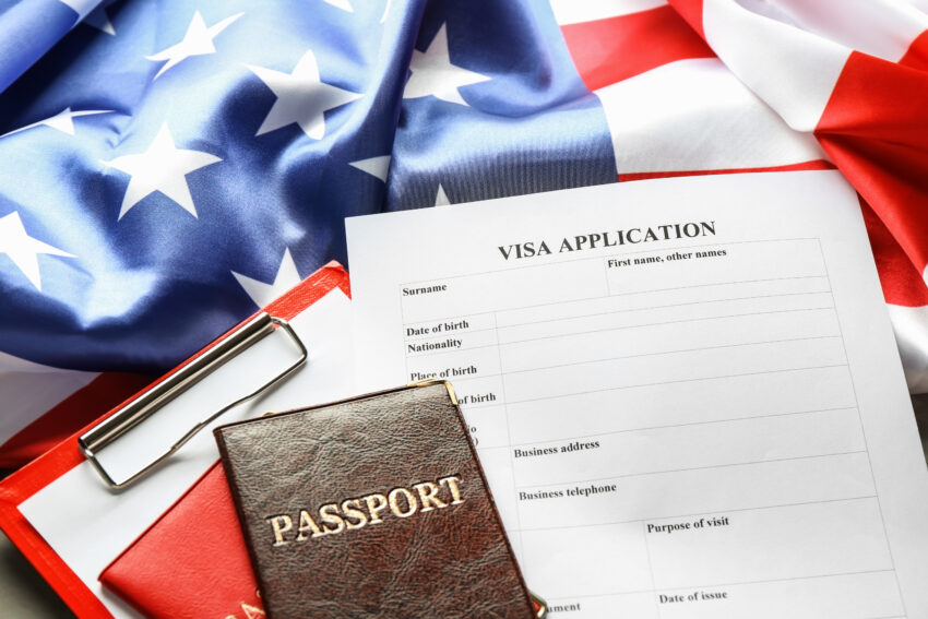 Passports,,American,Flag,And,Visa,Application,Form,On,Table.,Immigration