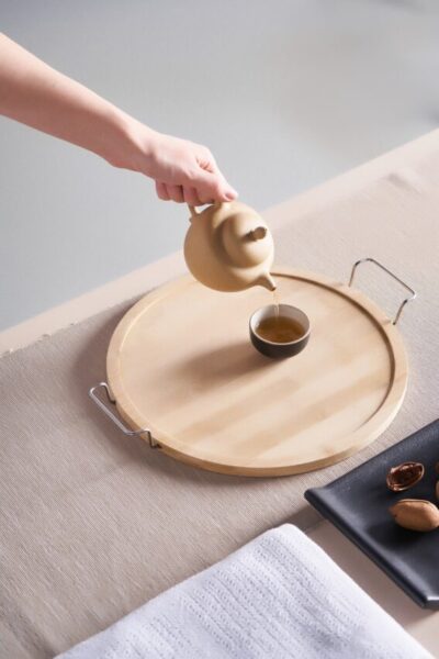 Cropped,Close-up,Shot,Of,A,Female,Hand,Pouring,Tea,From