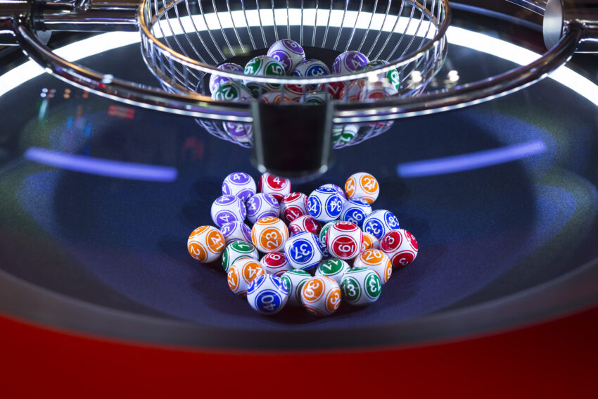 Colourful,Lottery,Balls,In,A,Rotating,Bingo,Machine.