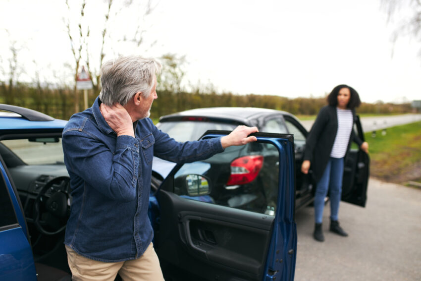 Senior,Male,And,Younger,Female,Drivers,Get,Out,Of,Cars