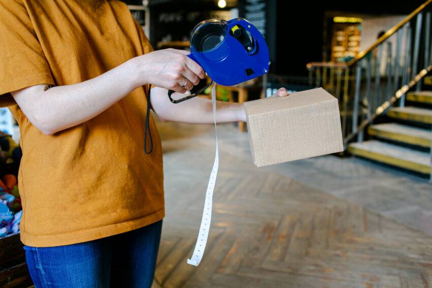 Hand,Of,The,Seller,Using,Labeling,Gun,For,Sticking,Price