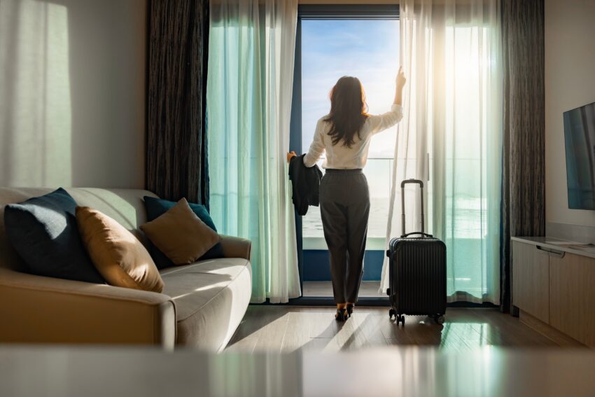 Confident,Businesswoman,Wearing,White,Shirt,And,Holding,Suit,With,Suitcase